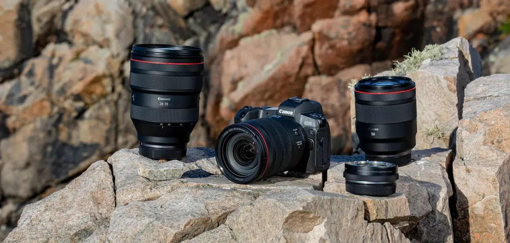 A Canon camera and two Canon camera lenses