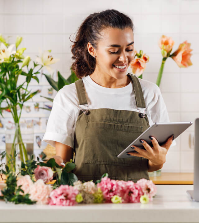 A florist looking at their tablet